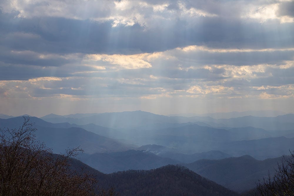 A view of Smoky Mountains with light beams shining down through clouds