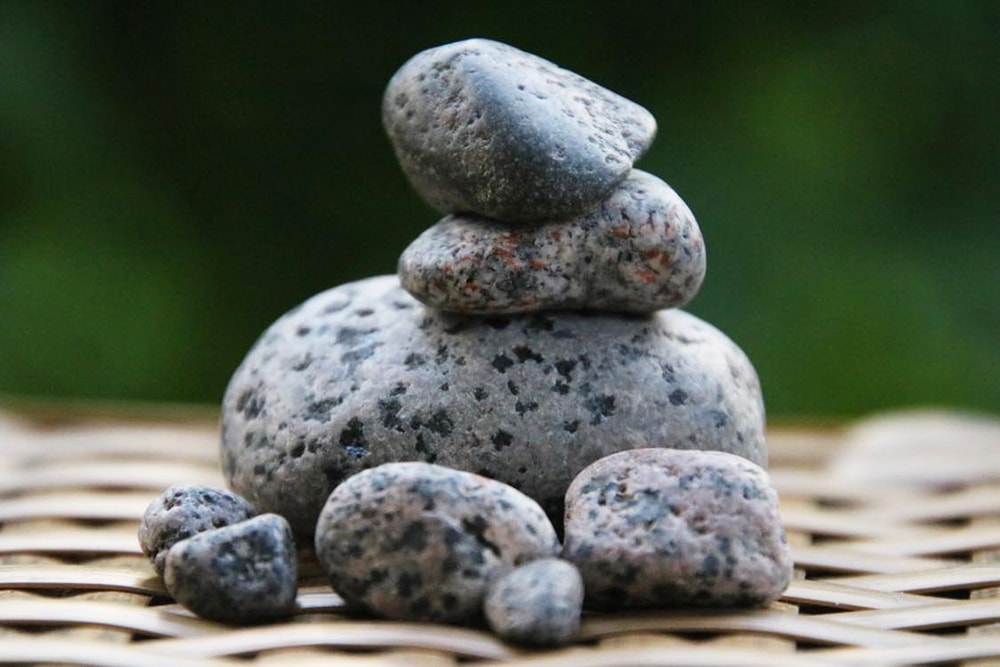 A picture of Yooperlite rocks stacked on top of each other in the daylight without a UV blacklight flashlight.
