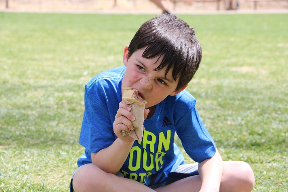 A boy eating ice cream at Zion Lodge inside Zion National Park