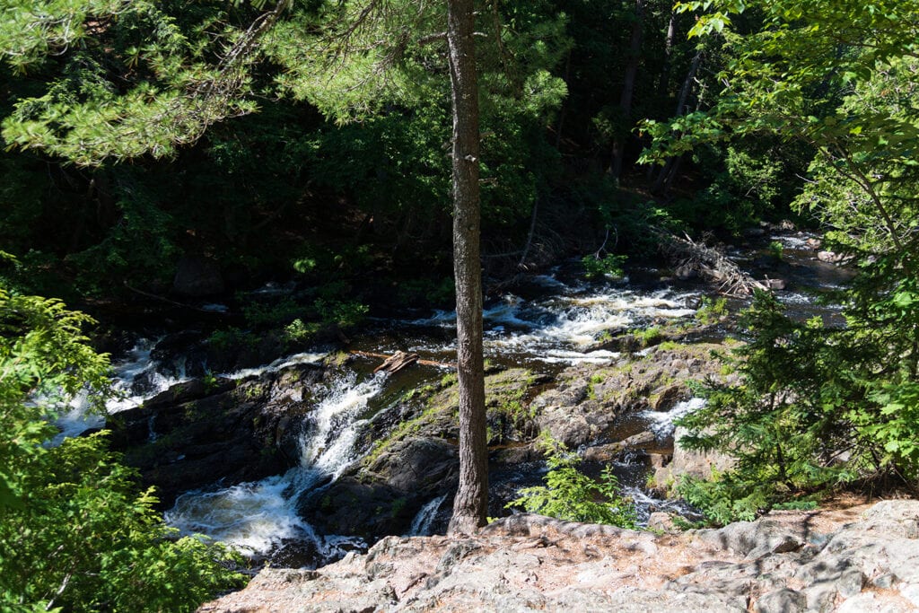 The first drop of Dead River Falls. A small rocky waterfall.