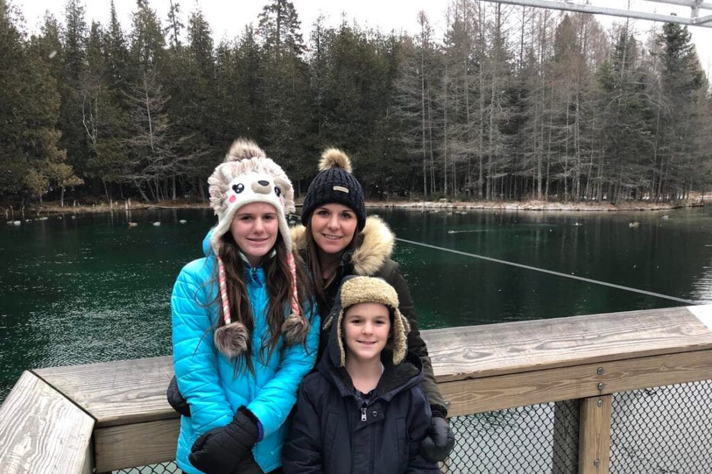 A view of Kitch-iti-kipi in the winter. The water is a deep emerald green.