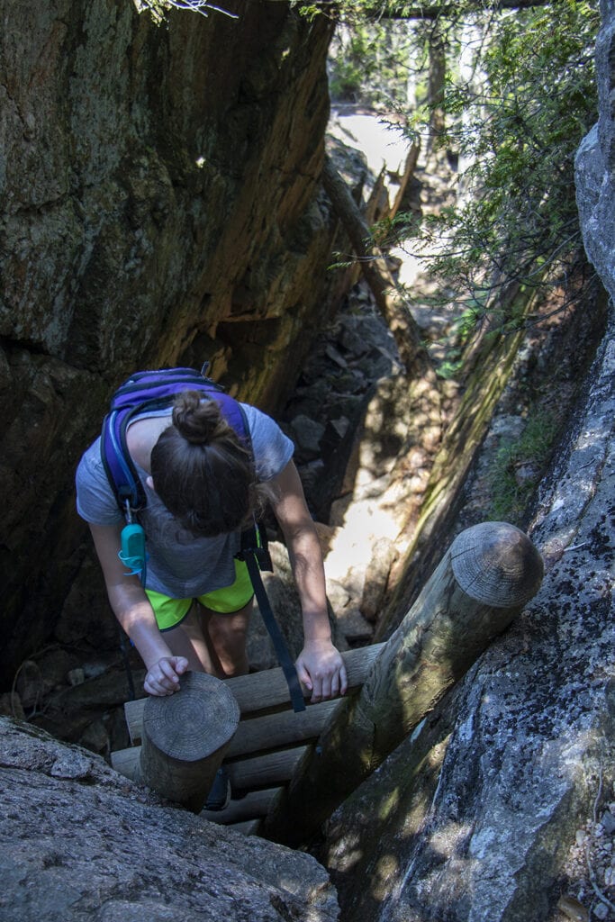 Climbing down the ladder on Pemetic Mountain Trail in Acadia.