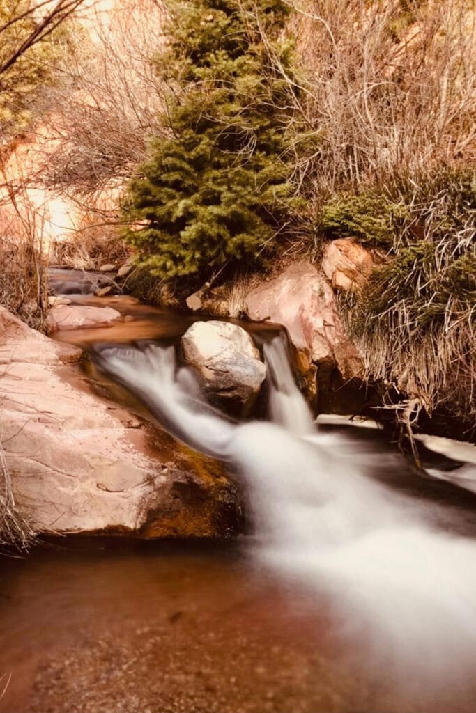 A tiny but beautiful waterfall on the way to the slot canyon. The cold, crystal clear water flows around a large boulder making it seem like its two waterfalls.