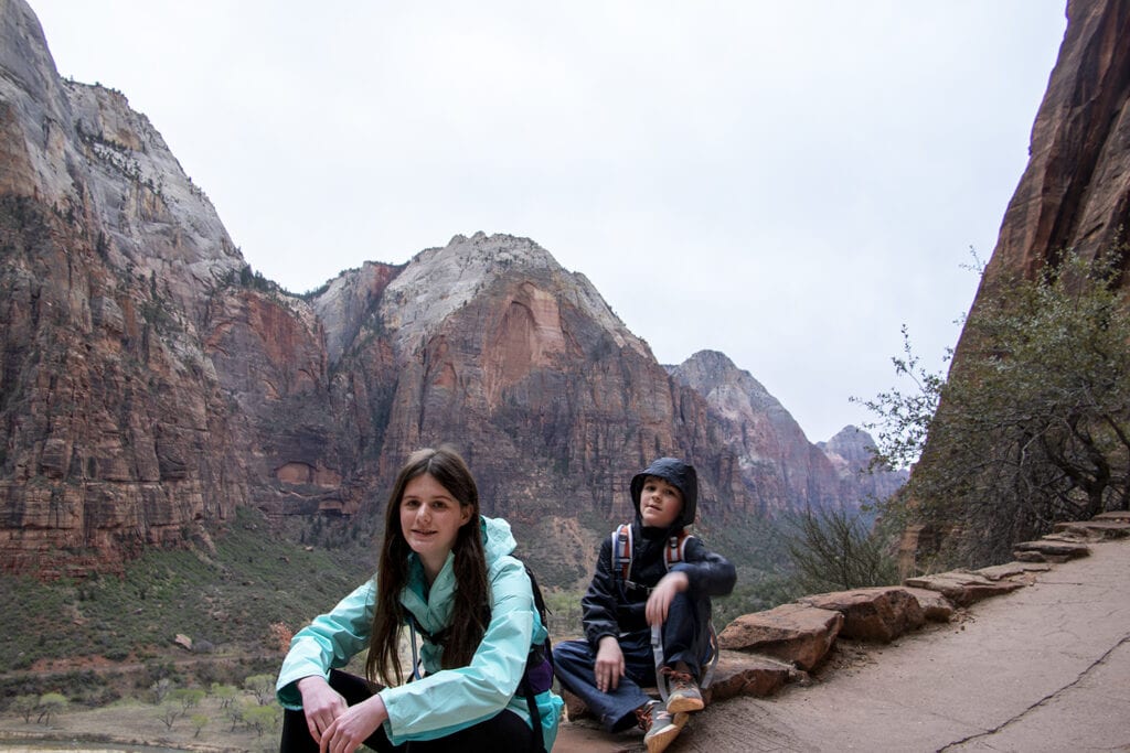 Kids resting while hiking to Scout's Lookout in Zion National Park