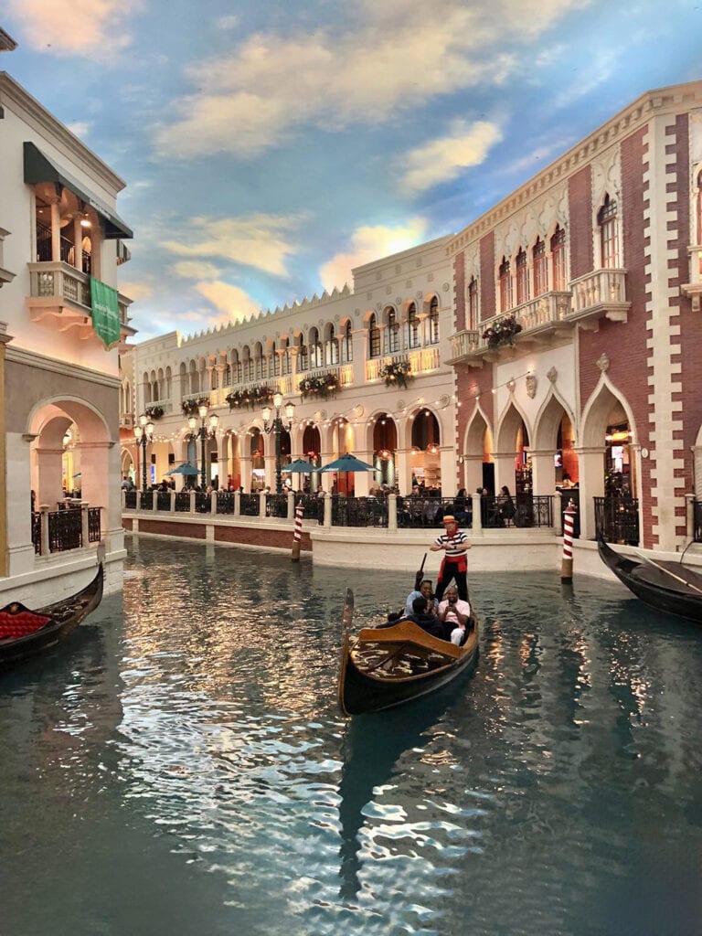 Family enjoying a gondola ride in Las Vegas, a fun-filled day trip from Zion National Park. Exploring the vibrant cityscape and entertainment of Las Vegas.