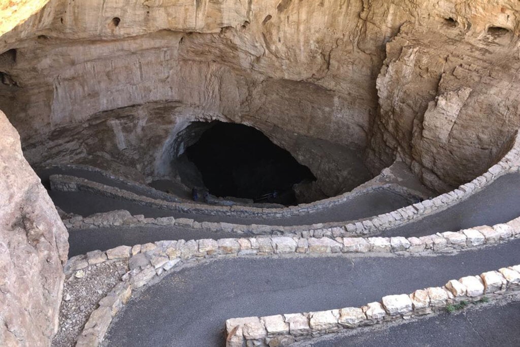 Entrance to Carlsbad Caverns, a natural wonder. The rocky path leading into the cave, showcases the park's captivating geological formations.